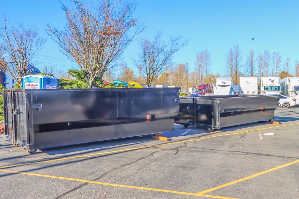 Professional dumpster rental service with roll-off container on residential driveway in Oatfield